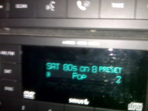 2008 Jeep Wrangler - The car's stereo system displays the SiriusXM radio station and song information.