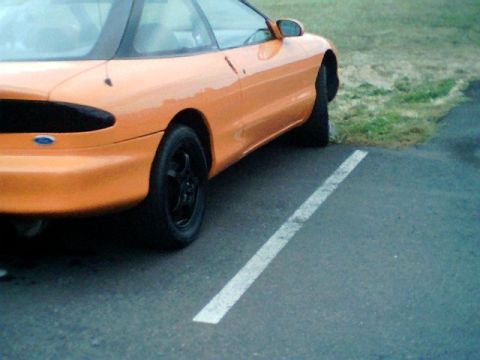1995 Ford Probe - The rear of an orange 1995 Ford Probe is shown parked in a lot.