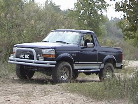1995 Ford Bronco - Dark blue 1995 Ford Bronco with aftermarket bumper and KC lights.