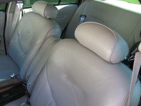 1998 Ford Crown Victoria - The interior of a car shows the rear seats and seatbelts.