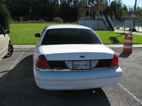 1998 Ford Crown Victoria - Rear view of a white 2003 Ford Crown Victoria parked in a lot.
