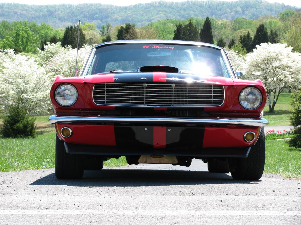 1966 Ford Mustang front view with red and black stripes on hood and body