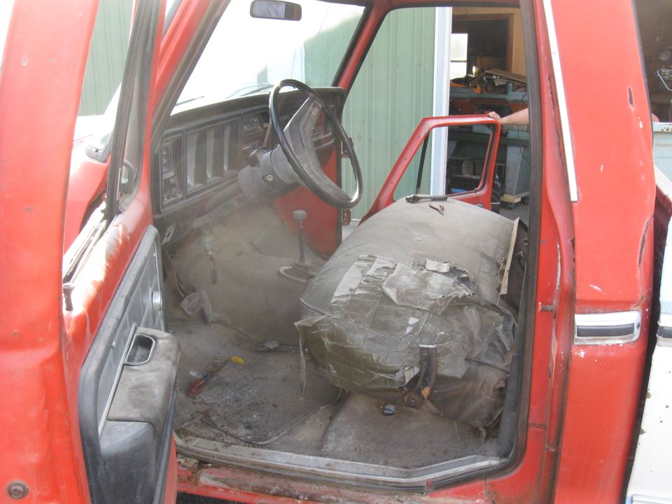 Red truck interior, showing worn seats and dashboard