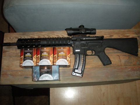 1996 Ford Bronco - An AR-15 style rifle is displayed with multiple boxes of Federal 550-round value packs of 22 long rifle ammunition.