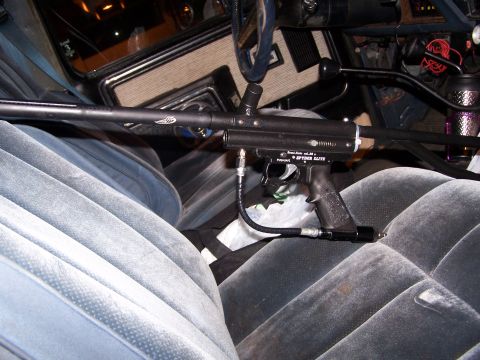 1986 Ford Bronco - A paintball gun is placed on the seats of a vehicle's interior. The gun has 'SPIDER ELITE' visible.