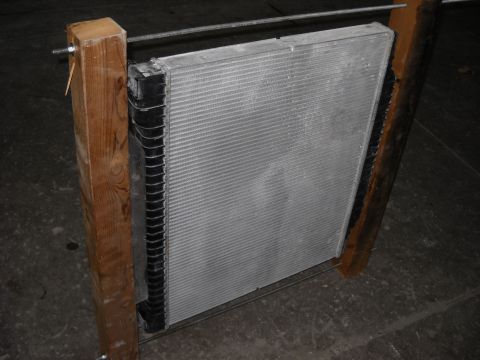 1986 Ford C-350 (Centurion Conversions) - A radiator is shown mounted in wooden supports, likely for repair or testing.