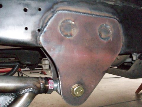 1996 Ford Bronco - This photo shows a close-up view of a modified vehicle frame with a heavy-duty bracket and bolt assembly.