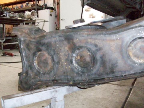 1996 Ford Bronco - A close-up view of a vehicle's suspension component, showing weld marks and the number 38 stamped on it.