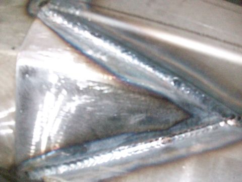 1996 Ford Bronco - Close-up of a welded metal component, possibly part of a vehicle frame, with a Supermotors.net watermark.