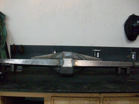 1996 Ford Bronco - A rear axle assembly is shown on a workbench in front of a wall with electrical outlets.
