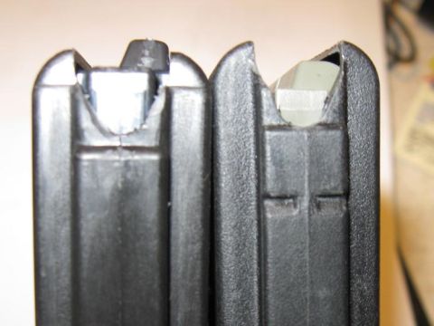 2000 Ford Crown Victoria - Comparison of two firearm magazines, highlighting differences in their construction and feed lip design.