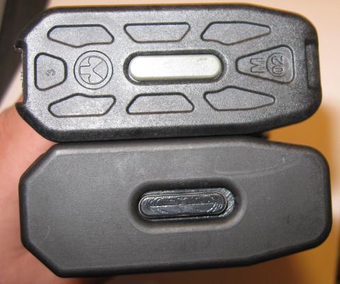 2000 Ford Crown Victoria - Close-up view of two electronic key fobs, one with visible buttons and markings, the other with a smooth surface.