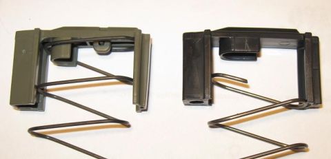 2000 Ford Crown Victoria - Comparison of two automotive hood latch mechanisms, one green and one black, each with a coiled spring.