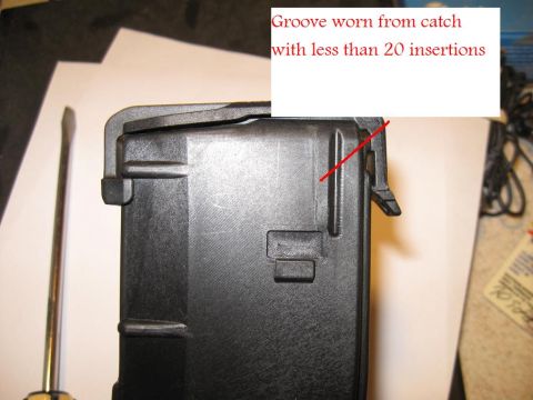 2000 Ford Crown Victoria - Close-up of a black plastic part showing a groove worn from the catch, with a red line indicating the wear.