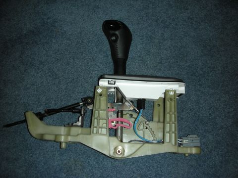 1998 Ford Crown Victoria - Disassembled automatic transmission shifter assembly with visible wiring and mechanical components.