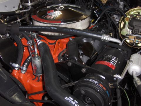1970 Chevrolet Camaro - Engine bay detail shot a 396 cubic inch V8 engine with chrome air cleaner and visible AC components.