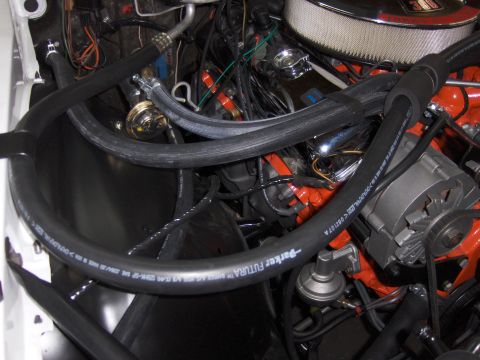 1970 Chevrolet Camaro - Close-up view of an engine bay, showing various hoses, wiring, and the alternator.