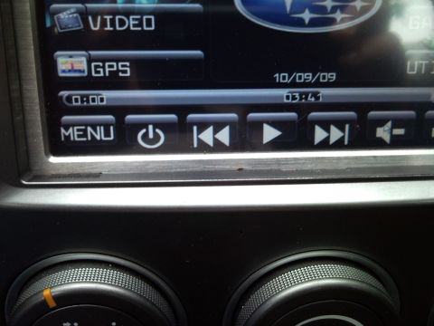 2007 Subaru Impreza - Close-up of a Subaru infotainment system display with media playback controls visible.