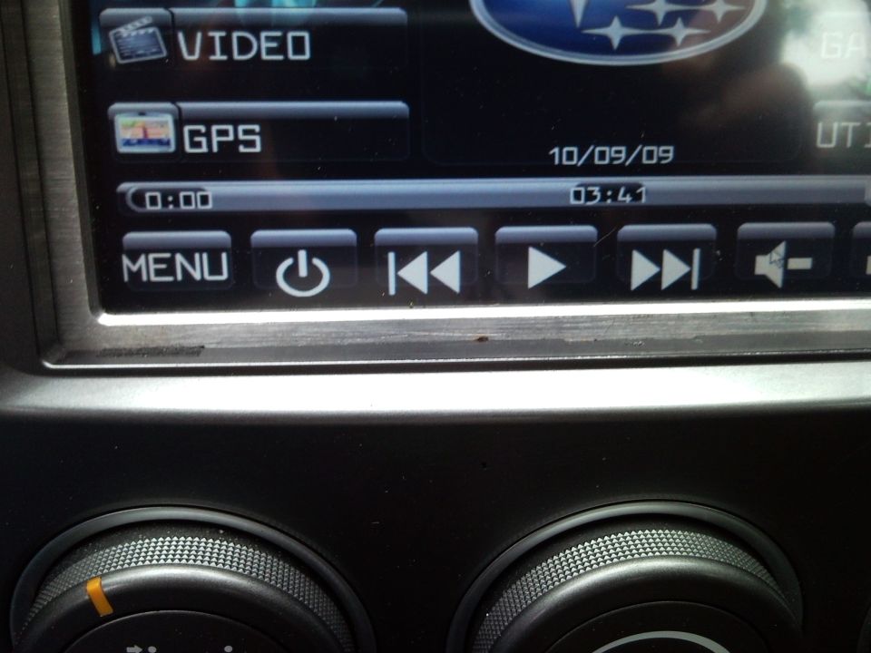 Subaru infotainment screen showing VIDEO and GPS options, with media controls and date 10/09/09