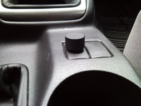 2007 Subaru Impreza - Close-up of an aftermarket knob installed on the center console of a vehicle.