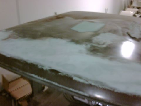 1979 Ford F-250 - The roof of a vehicle is shown with body filler and primer, indicating repair work is in progress.