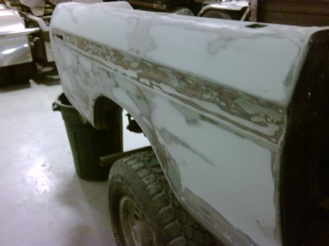 1979 Ford F-250 - This 1979 Ford F-250 crewcab body panel is undergoing repair work, with primer and filler visible.