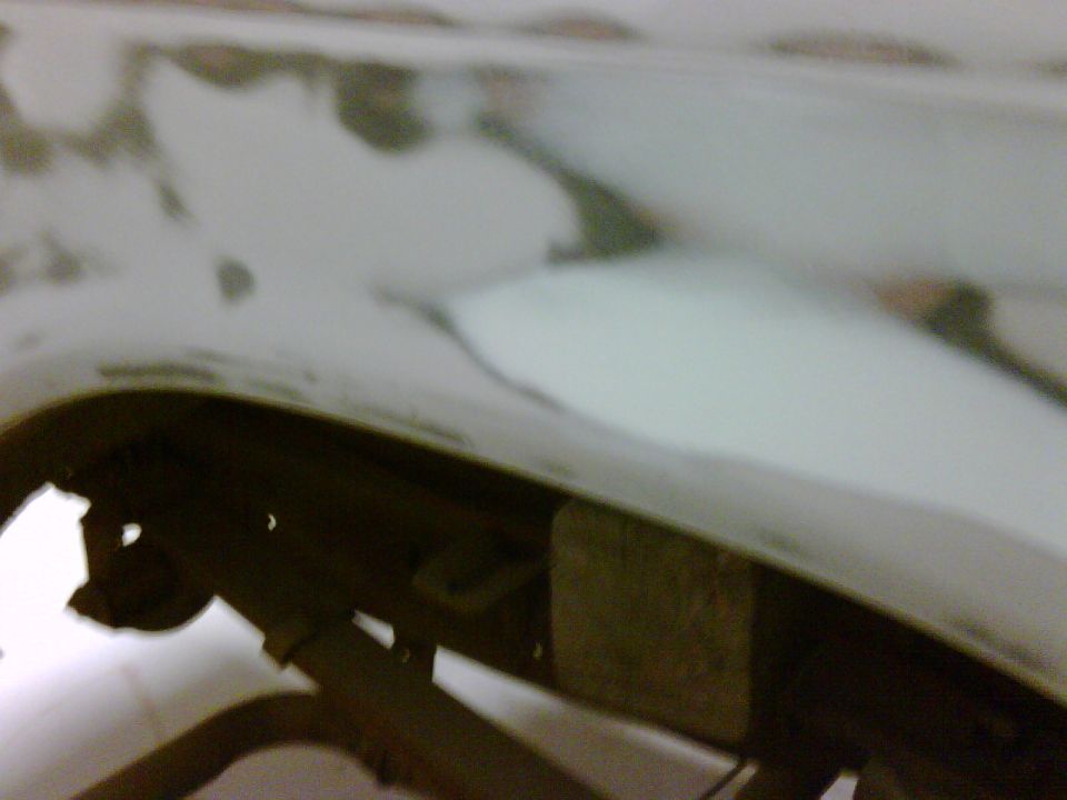 close-up of body filler on a vehicle's rear fender area