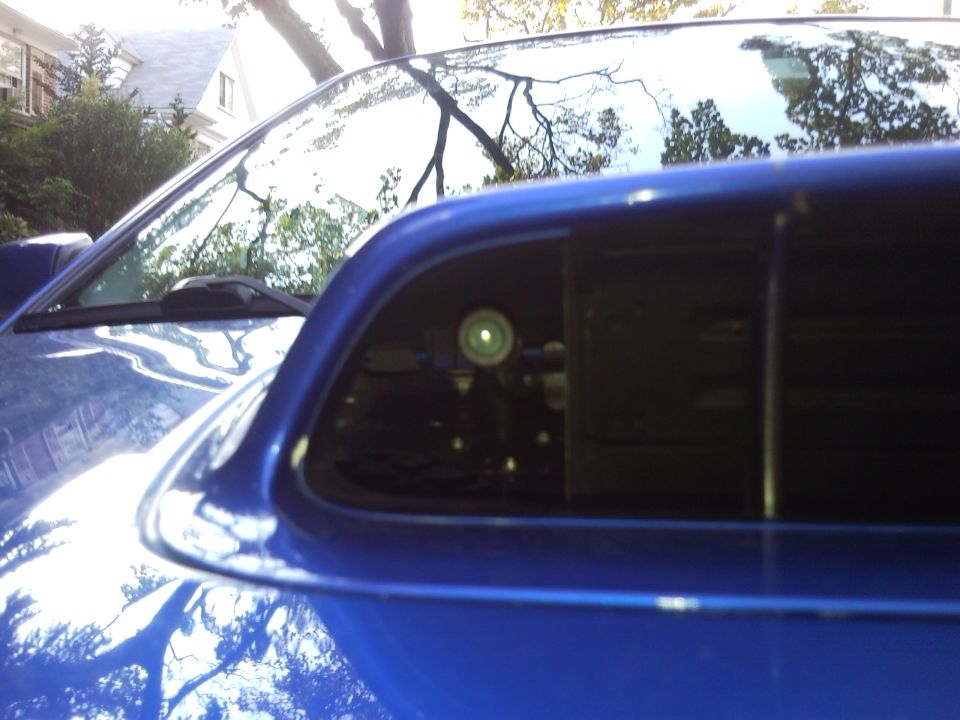 Blue Subaru Impreza hood scoop with a small camera visible inside