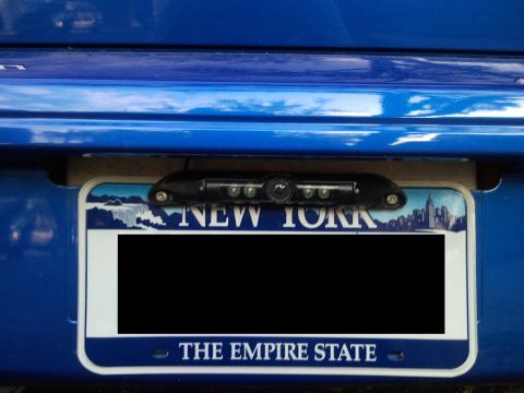 2007 Subaru Impreza - A New York license plate is mounted on the rear bumper of a blue vehicle, with a backup camera installed above it.
