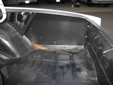 1991 Ford LTD Crown Victoria - The interior of a car's trunk is shown, appearing empty and somewhat worn.