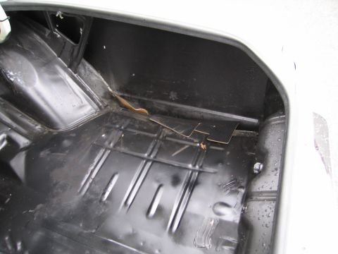 1991 Ford LTD Crown Victoria - Interior view of an empty car trunk with visible floor ribs and side paneling.