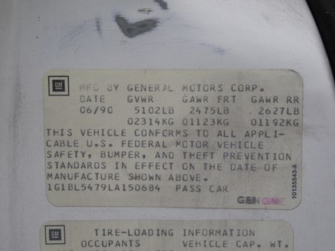 1991 Ford LTD Crown Victoria - GM certification data plate stating compliance with federal standards, with date, GVWR and VIN.