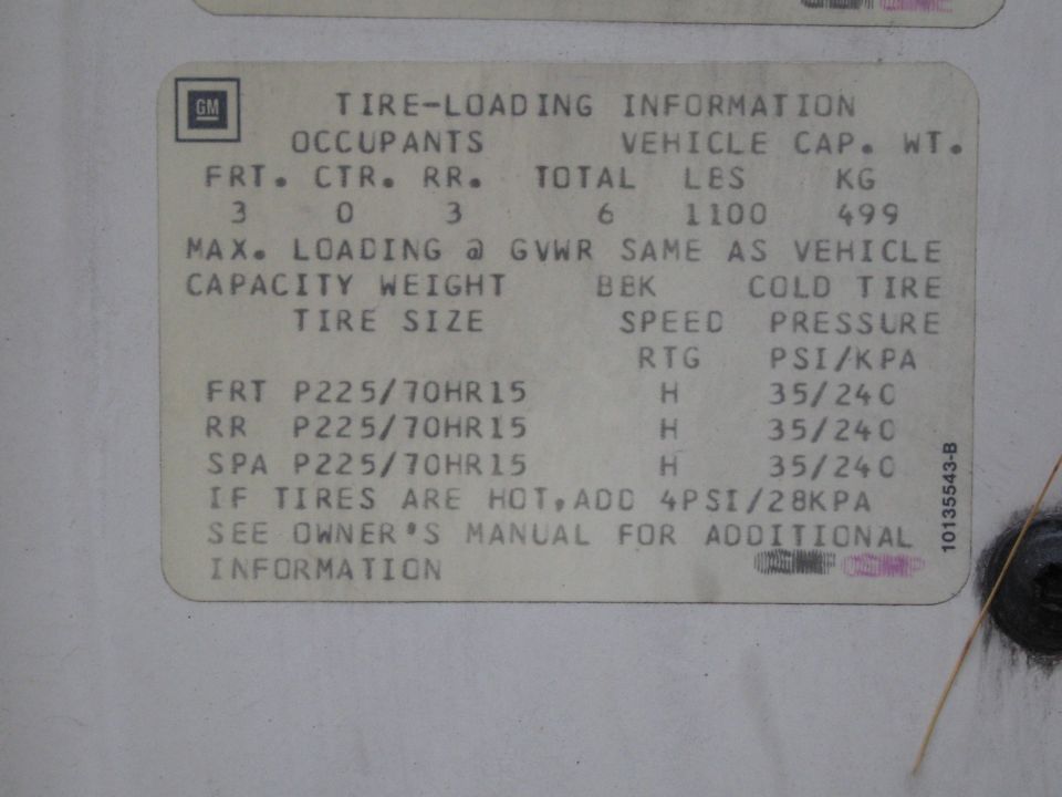 GM tire-loading information placard listing tire sizes and pressures