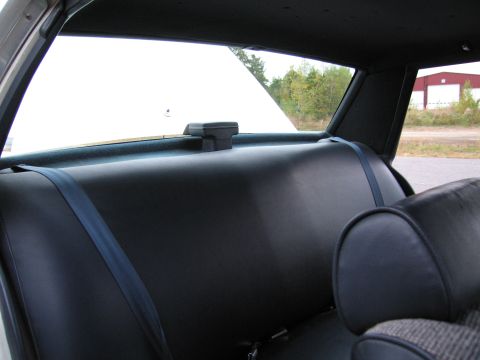 1991 Ford LTD Crown Victoria - View of the rear interior of a vehicle, showing the back seat and seatbelts.