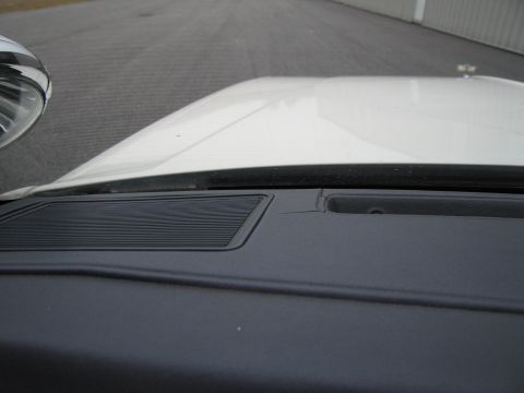 1991 Ford LTD Crown Victoria - Interior view of a car's dashboard showing a speaker grille and a crack.