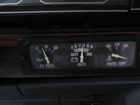 1991 Ford LTD Crown Victoria - Close-up of a car's dashboard gauges showing oil pressure, voltage, and water temperature readings.