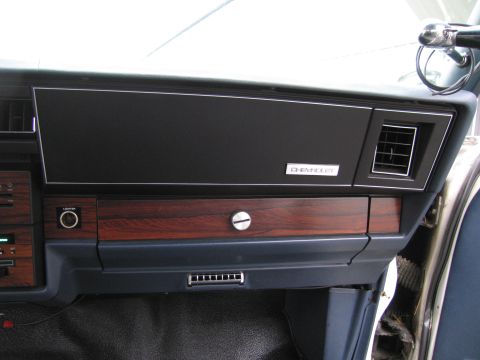 1991 Ford LTD Crown Victoria - Interior view of a Chevrolet dashboard with woodgrain accents and a prominent Chevrolet badge.