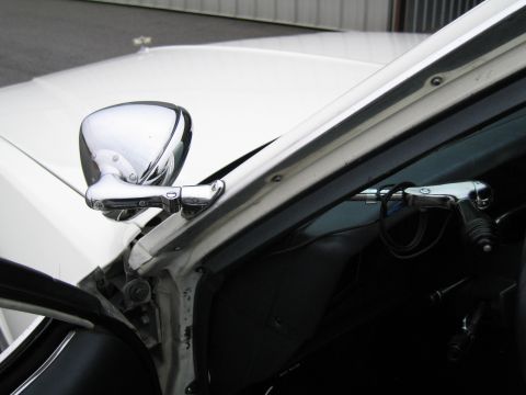 1991 Ford LTD Crown Victoria - Close-up view of the driver's side interior and exterior mirror of a white vehicle.