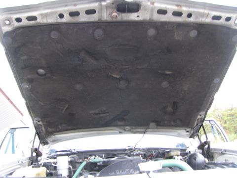 1991 Ford LTD Crown Victoria - Car engine bay with hood open, showing insulation and engine components. Text visible on fan shroud.