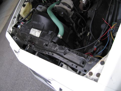 1991 Ford LTD Crown Victoria - The engine bay of a car, with various components and wiring visible.
