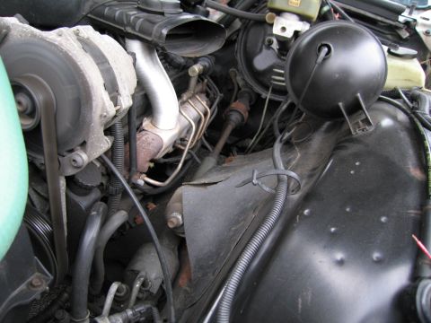 1991 Ford LTD Crown Victoria - Close-up view of an engine bay, showing various components like the alternator and brake booster.