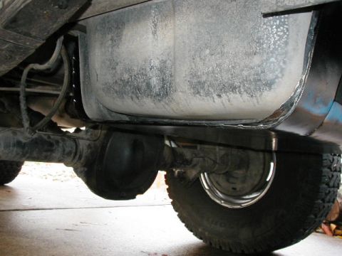 1995 Ford Bronco - Underside view of a vehicle's fuel tank and rear axle, showing mechanical components.