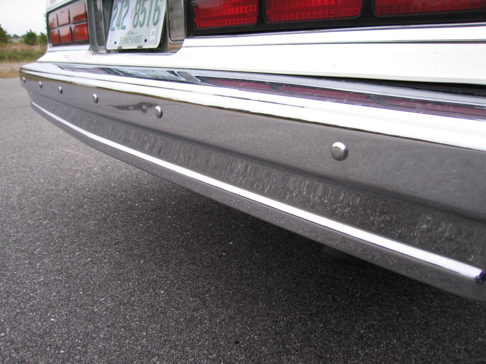 Rear bumper and taillight of a car with license plate 242 8516