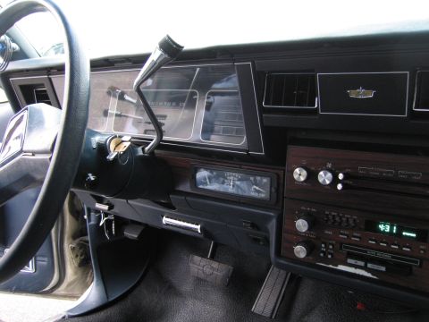 1991 Ford LTD Crown Victoria - The dashboard and interior of a 1990s era car, a column shifter and analog gauges.