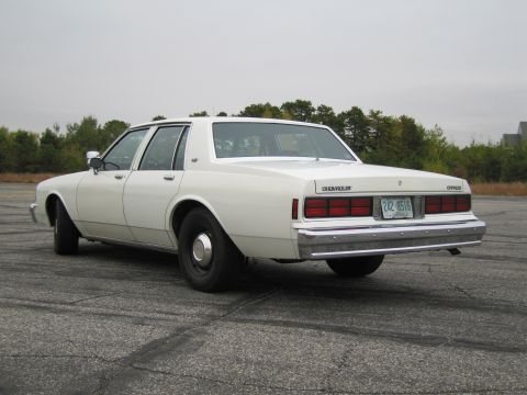 1991 Ford LTD Crown Victoria - This Chevrolet Caprice sedan displays a classic 1980s body style with its distinctive rear end and chrome accents.