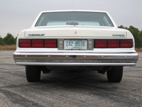 1991 Ford LTD Crown Victoria - Rear view of a white Chevrolet Caprice sedan, displaying its distinctive taillights and license plate.