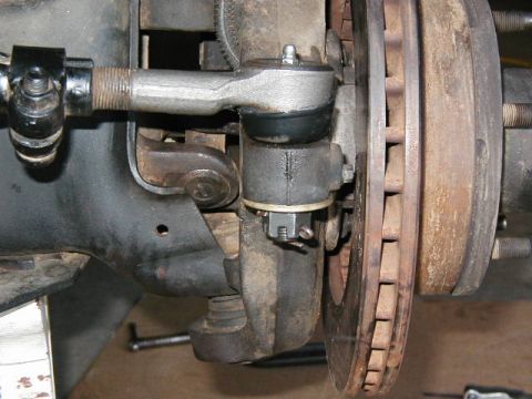 1995 Ford Bronco - Stock, the steering linkage/tierod is mounted under the knuckle. We have moved it to the top.