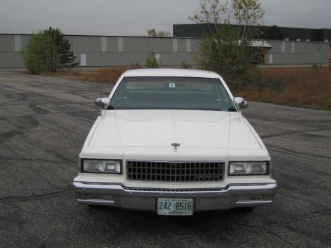 1991 Ford LTD Crown Victoria - Front view of a white 1986 Chevrolet Caprice with a chrome grille and a license plate reading 242 8516.