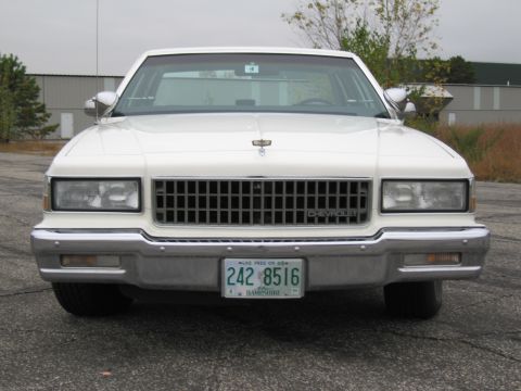 1991 Ford LTD Crown Victoria - This Chevrolet Caprice sedan displays a prominent chrome grille and a front-facing view.