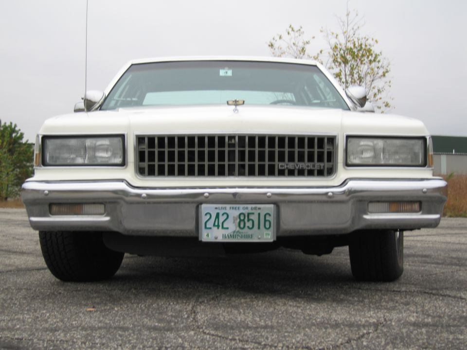 Front view of a white Chevrolet Caprice sedan with a chrome grille and license plate